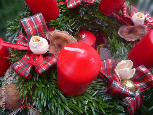 Christmas decoration with green branches and red candles photo