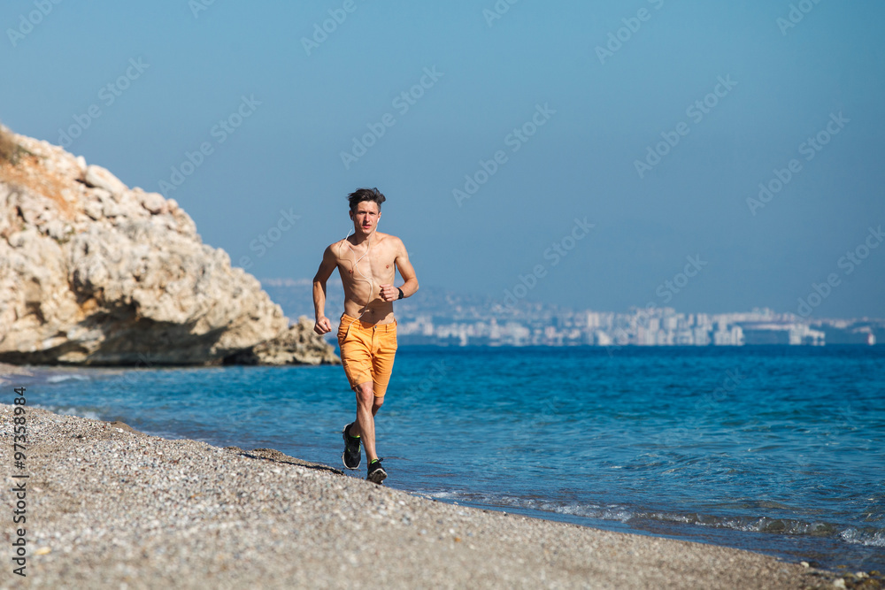 Man running at sunrise on the water