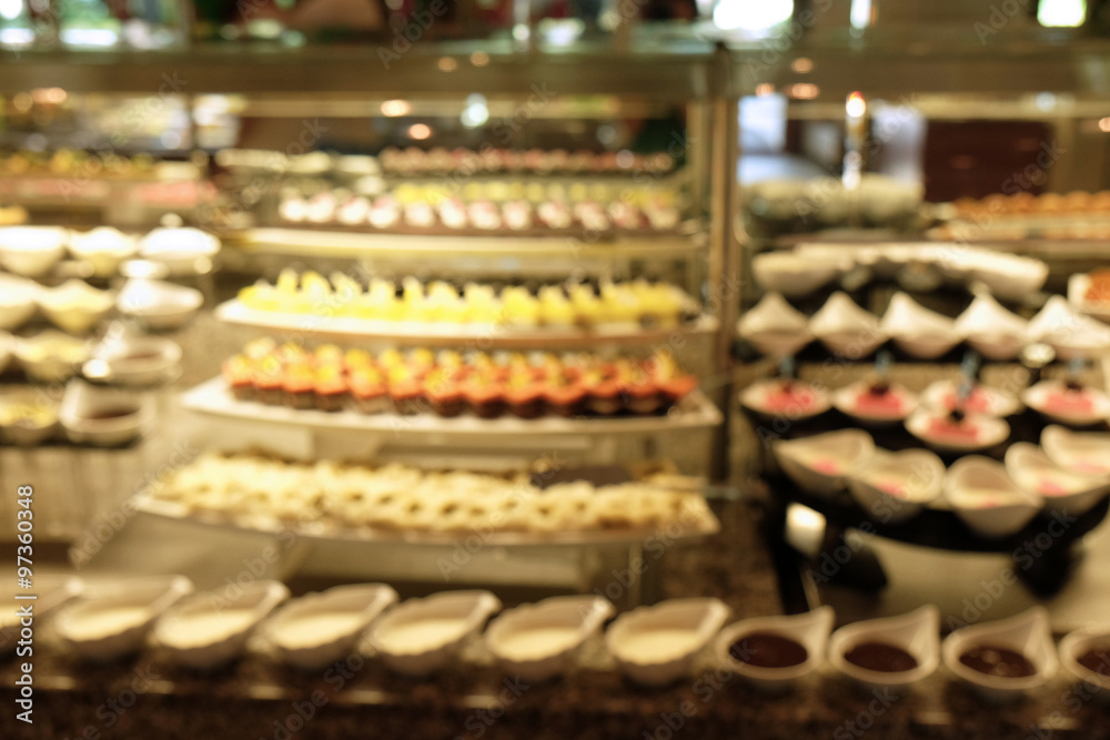 Defocused background of different dessert cakes for sale at the shop Defocused background of different dessert cakes for sale at the shop