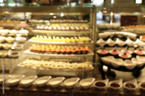 Defocused background of different dessert cakes for sale at the shop