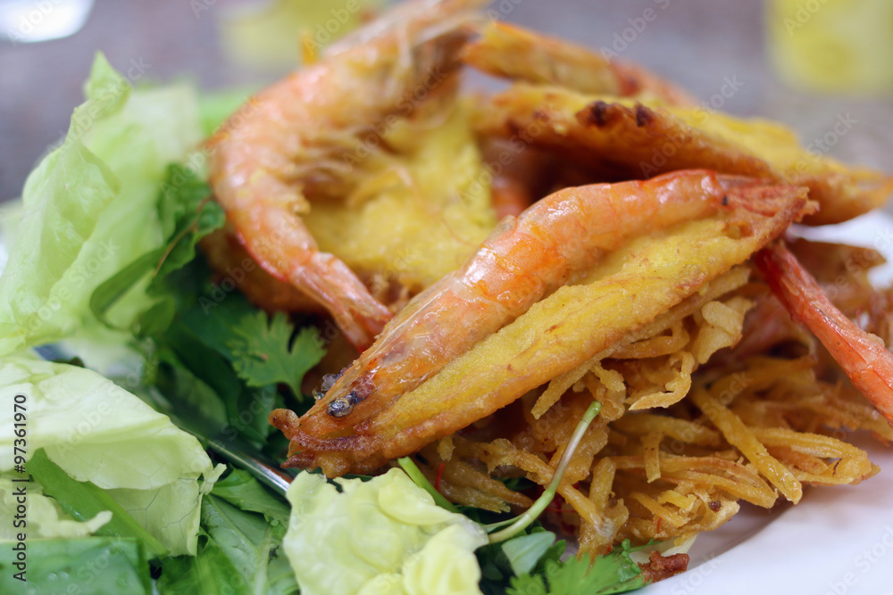 Vietnamese cafe. Fried shrimps with salad, egg and potatoes Vietnamese cafe. Fried shrimps with salad, egg and potatoes