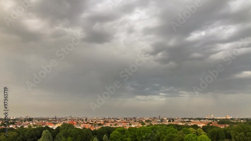 Beautiful time lapse of the skyline of Amsterdam with clouds and a rainbow