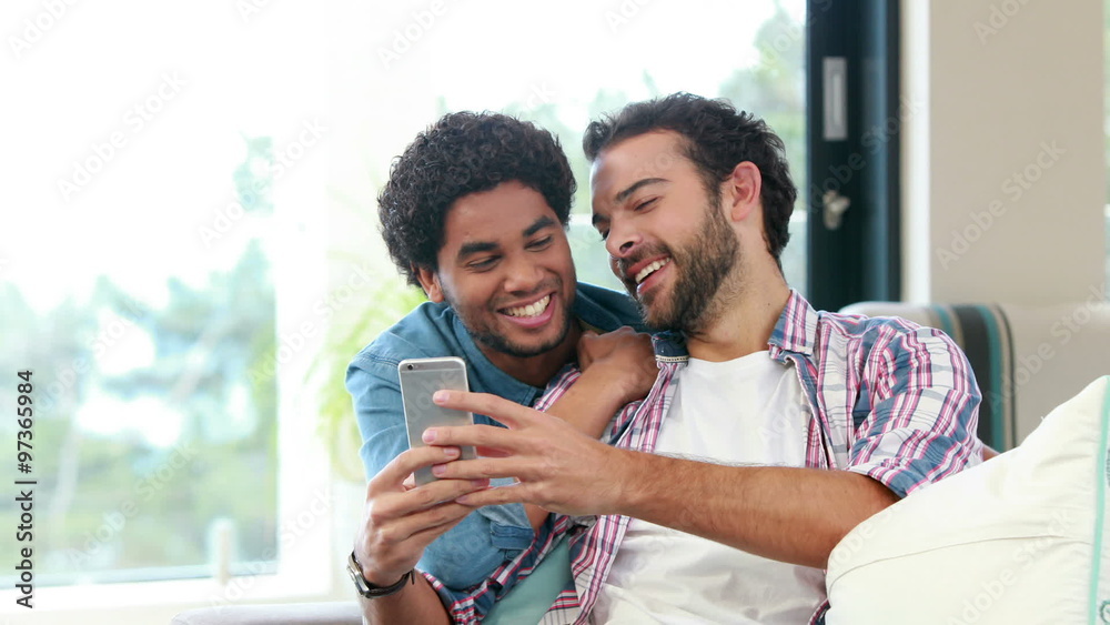 Gay couple on smartphone together Gay couple on smartphone together