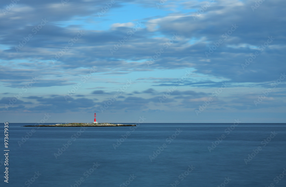 Red lighthouse on small island, on background cloudy sky. Red lighthouse on small island, on background cloudy sky.