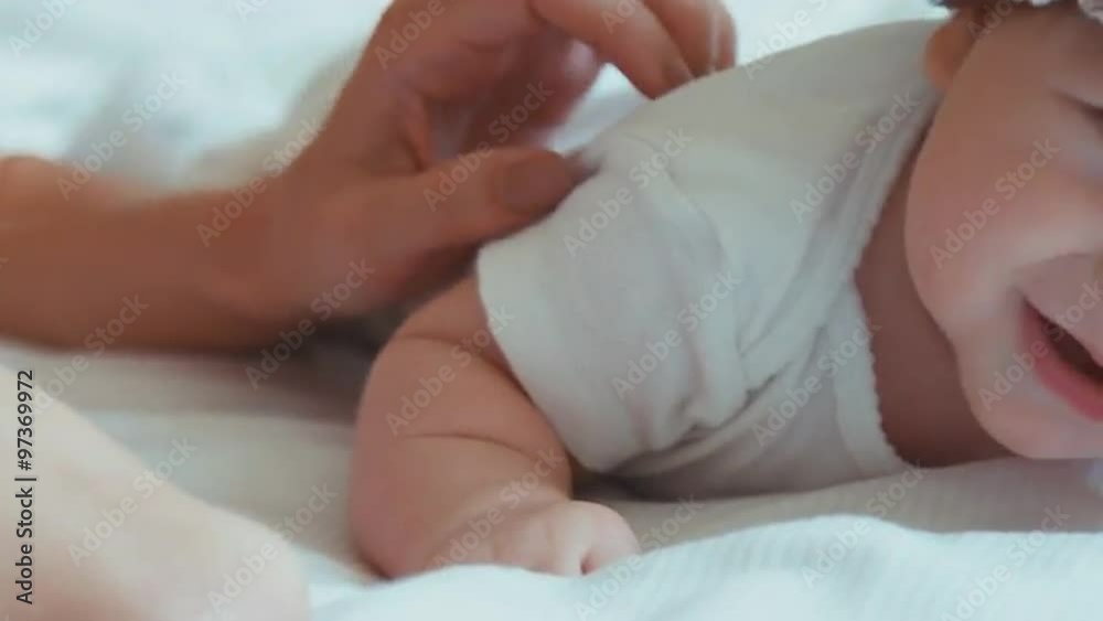 Closeup portrait mother playing with newborn child Closeup portrait mother playing with newborn child