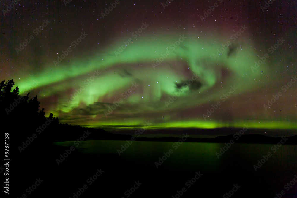 Aurora borealis swirls dancing over Lake Laberge Yukon Canada