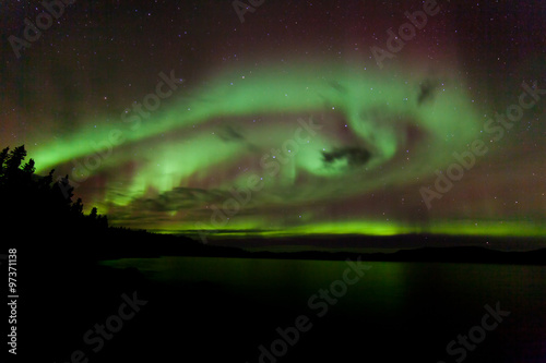 Aurora borealis swirls dancing over Lake Laberge Yukon Canada