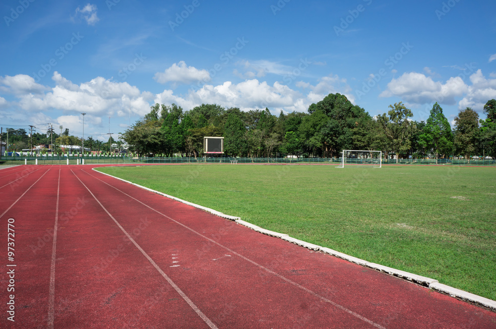 Fototapeta premium race track , football field with blue sky