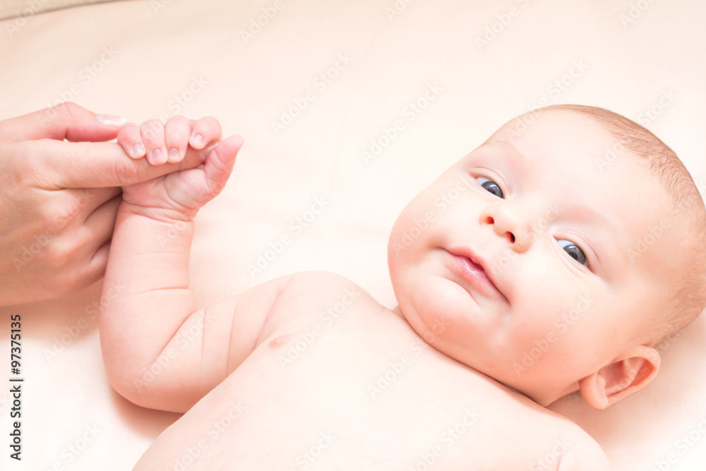 © Alisa Bezukladnikova - 2 month old baby holding mother's finger and smiling © Alisa Bezukladnikova - 2 month old baby holding mother's finger and smiling
