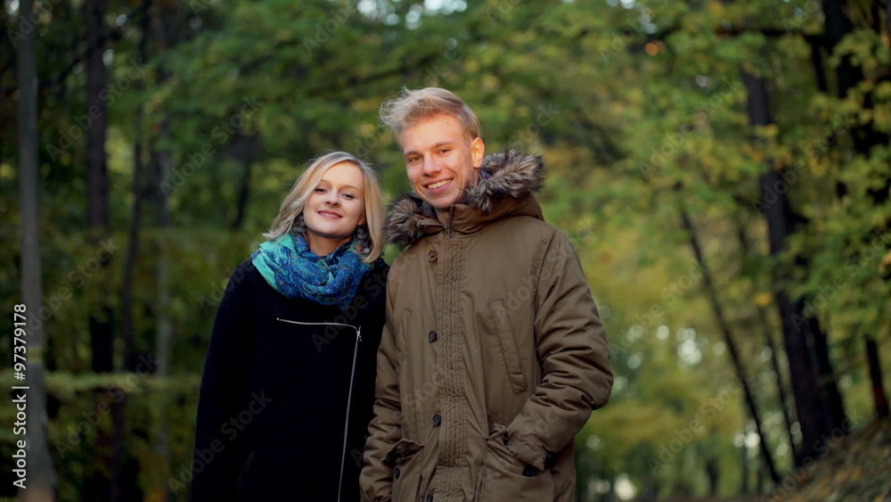 Lovely couple walking in the park and smiling to the camera
Lovely couple walking in the park and smiling to the camera