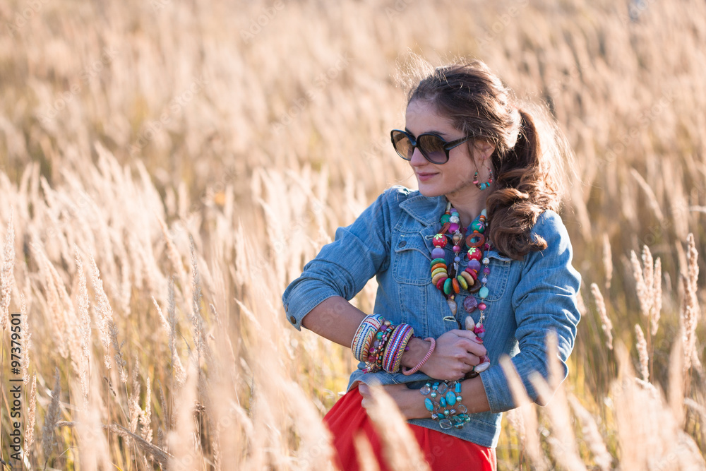 Portrait of attractive girl on the field in sunglasses Portrait of attractive girl on the field in sunglasses