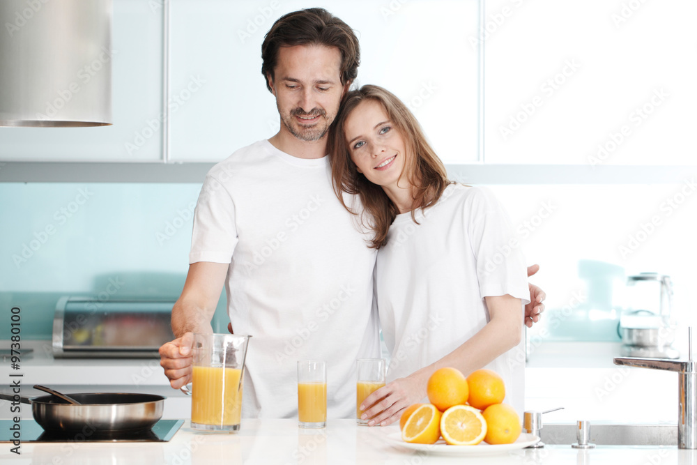 Couple with juice in the kitchen Couple with juice in the kitchen