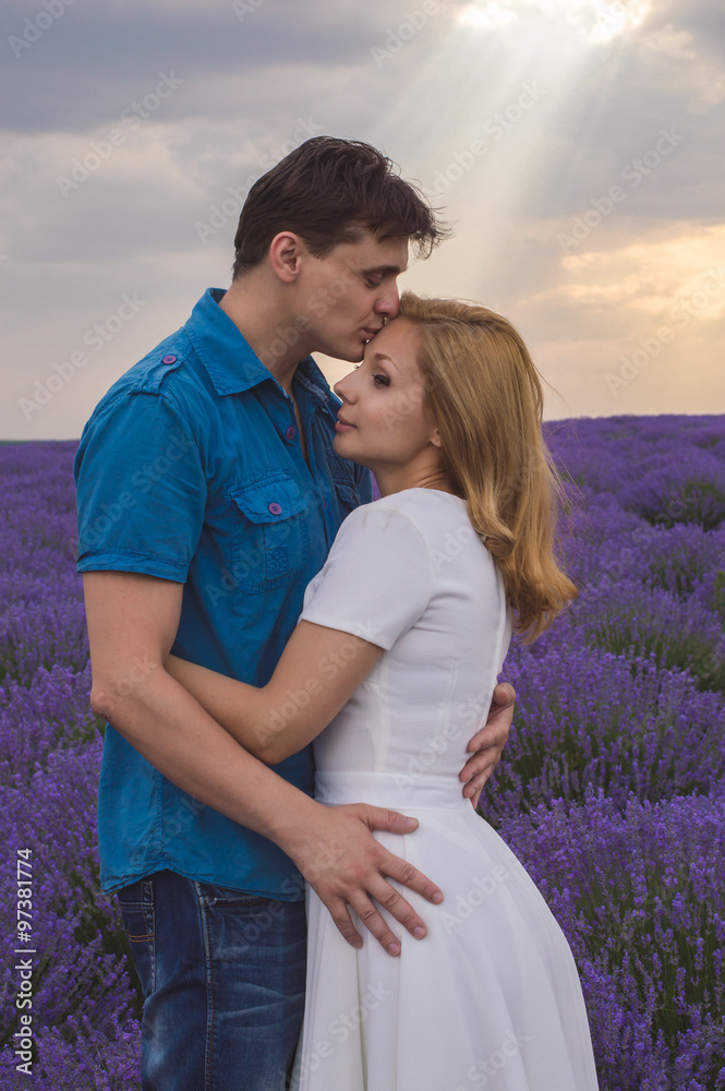 Happy young couple kissing each other on lavender field Happy young couple kissing each other on lavender field