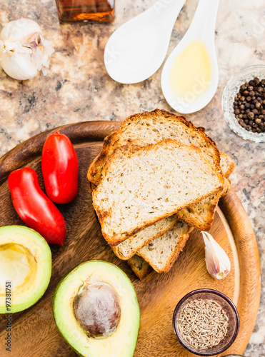 avocado halves, bread, tomatoes, a set of products for sandwiche