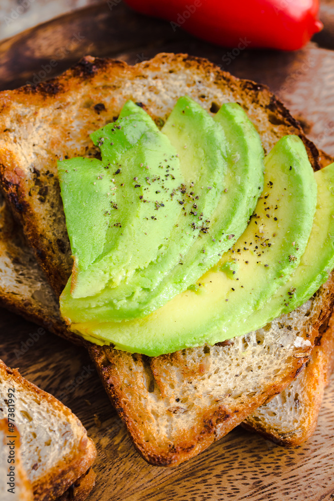 toast with fresh avocado and pepper, healthy snack, closeup toast with fresh avocado and pepper, healthy snack, closeup
