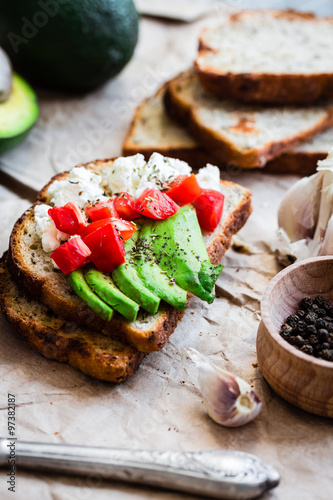 toast with fresh avocado, tomato and goat cheese, vegetarian sna