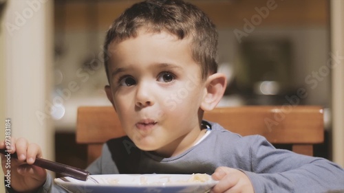 little boy eating soup