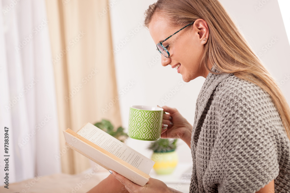 woman on the bed with old book and cup of coffee woman on the bed with old book and cup of coffee