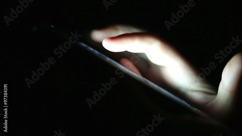 hands chatting alone at dark with smartphone, online talking with friends communicating