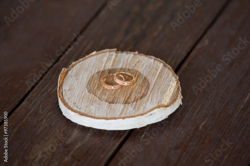Fototapeta Naklejka Na Ścianę i Meble -  wedding rings on wooden whetstone
