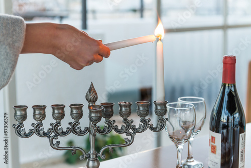 Lighting of candles for Hanukkah holiday. Hanukkah celebration attributes. Judaic holiday of lights.