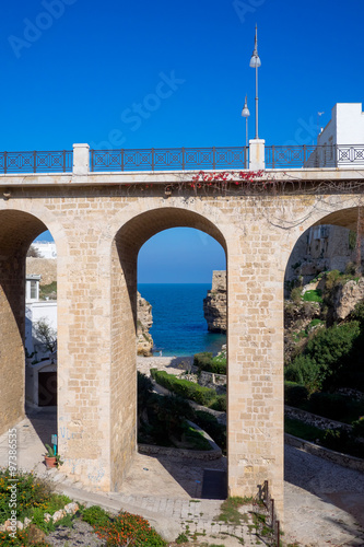 Stone bridge with a view of the sea on the background. Polignano a Mare - Apulia, Italy