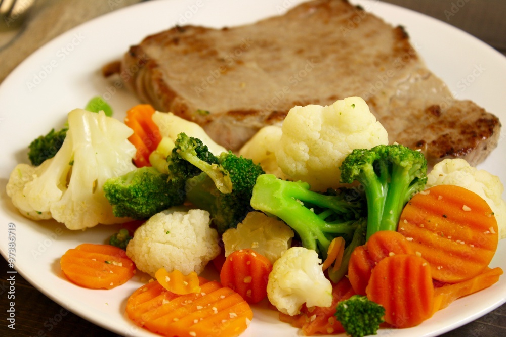 steak with vegetables on a wooden background steak with vegetables on a wooden background