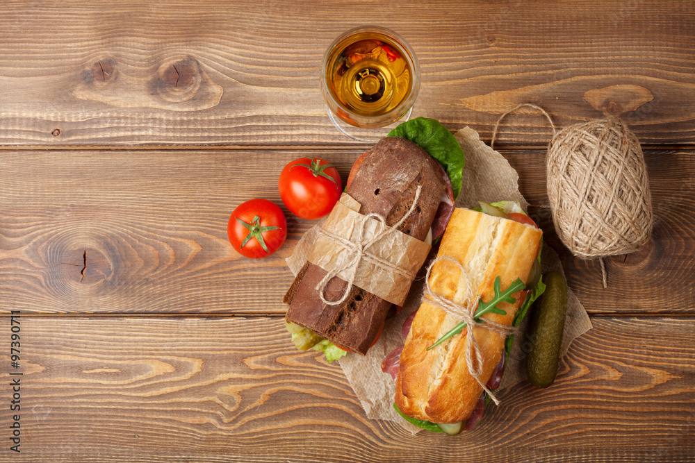 Two sandwiches and white wine glass Two sandwiches and white wine glass