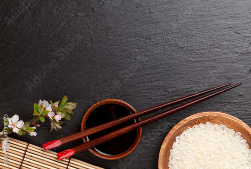 Japanese sushi chopsticks, soy sauce bowl, rice and sakura bloss