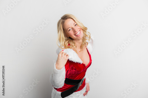 Happy woman dressed in sexy red Santa Claus costume