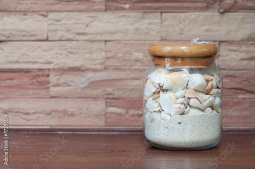 Jar with sand and shell