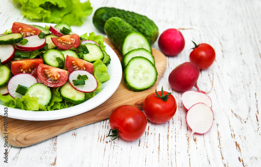 Spring salad with tomato, cucumbers and radish Spring salad with tomato, cucumbers and radish