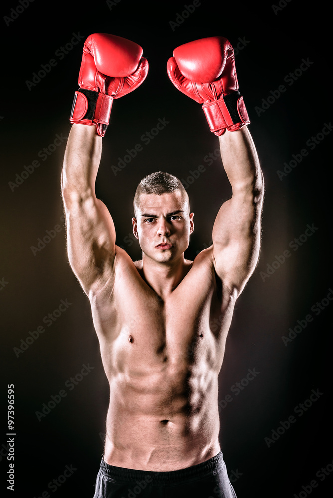powerful boxer raising gloves after victory