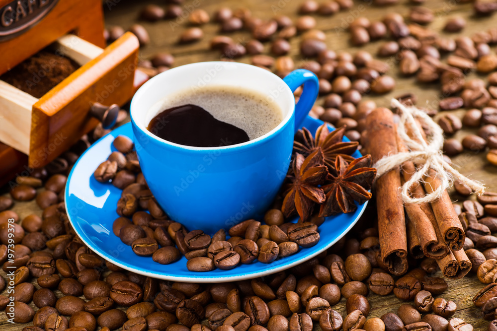 Fototapeta premium Coffee cup and saucer on a wooden table. Dark background, coffee