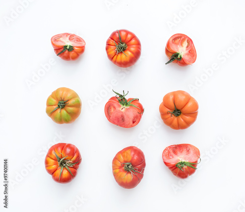  Selection of heirloom tomatoes on a white backdrop. photo