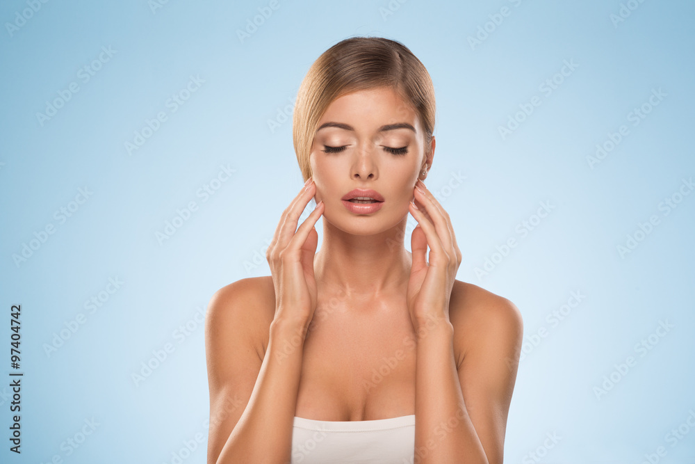 Portrait of beautiful natural blonde woman on blue background Portrait of beautiful natural blonde woman on blue background