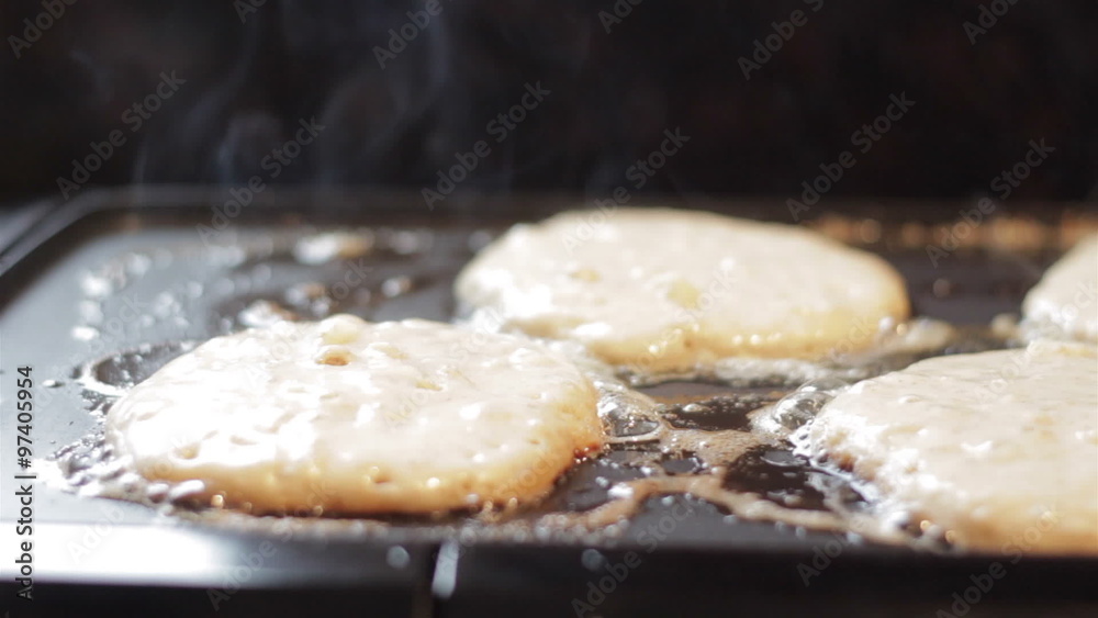 Closeup of home made apple pancakes cooking on an electric griddle Closeup of home made apple pancakes cooking on an electric griddle