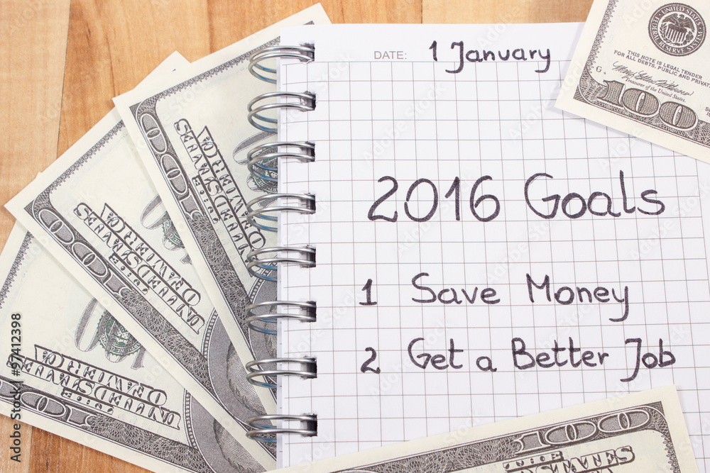 Obraz premium New years resolutions written in notebook and currencies dollar