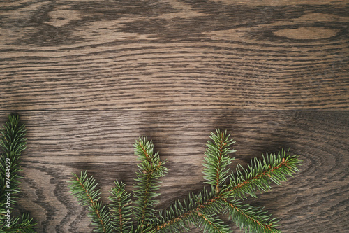 christmas fir tree branches on oak wooden background