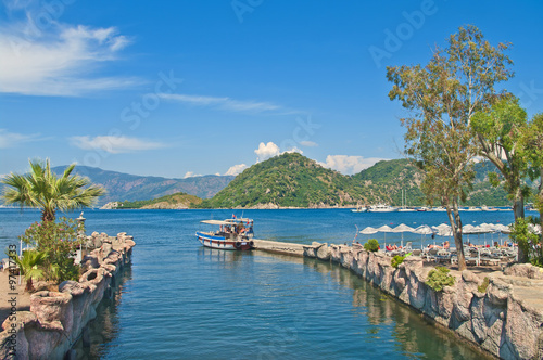 small tourist boat at pier in sea bay