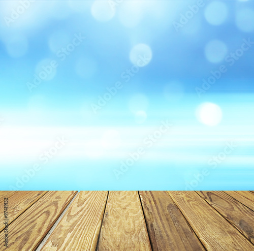 Empty wood table over blurred blue sky with bokeh background, product display template,deck,