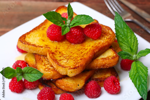 delicious French toast with raspberries and honey