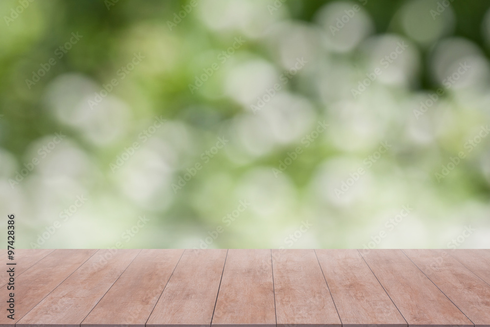 Wood table top on green bokeh abstract background. ready for product display Wood table top on green bokeh abstract background. ready for product display