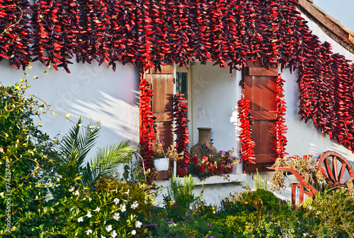 Red Espelette peppers decorating Basque house photo