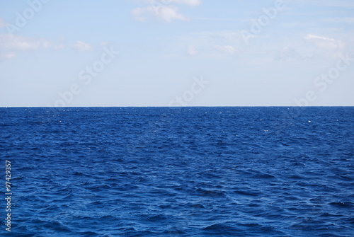 Deep blue water with blue sky on horizon © savanno