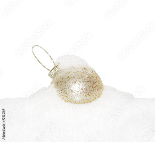 Gold Christmas New Year bauble, ball lying on the white snow, snow-covered, snowy, isolated on a white background