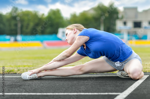  beautiful woman doing core workout at a stadium