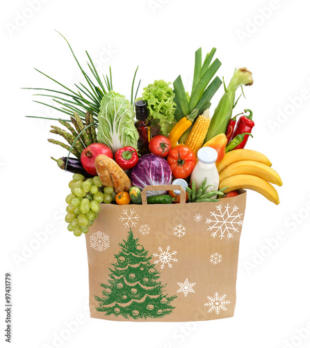 Christmas Holiday shopping bag / studio photography of brown grocery bag with fruits, vegetables, bread, bottled beverages - isolated over white background. High resolution product