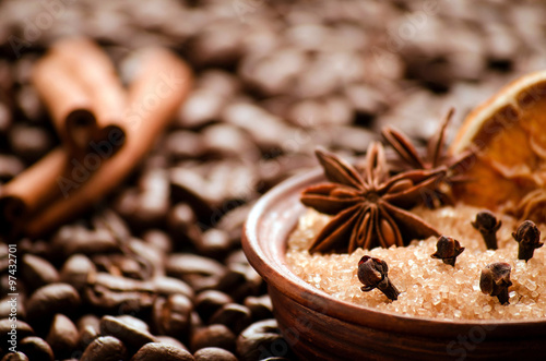 cane sugar and spices on background of coffee beans