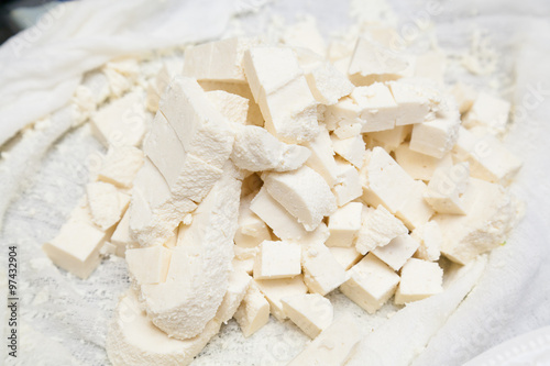 Closeup of paneer cut into pieces on buttercloth